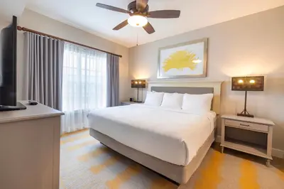 a bedroom with a large bed with a ceiling fan at WorldMark Orlando Kingstown Reef in Orlando