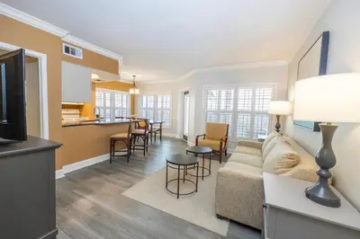 a living room with a couch and a kitchen at WorldMark Orlando Kingstown Reef in Orlando