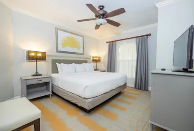a bedroom with a bed and a flat screen tv at WorldMark Orlando Kingstown Reef in Orlando