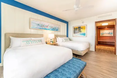 a hotel room with two beds and a ceiling fan at Margaritaville Resort Orlando with H2O Waterpark in Kissimmee