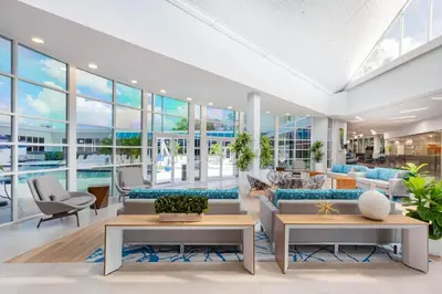 a living room with large windows and a pool at Holiday Inn Resort Kissimmee by the Parks by IHG in Orlando