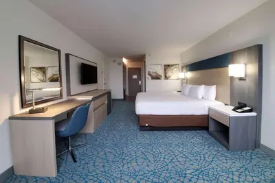 a hotel room with a bed and a desk and a computer at Holiday Inn Resort Kissimmee by the Parks by IHG in Orlando