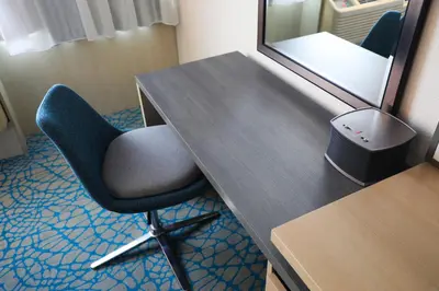 a desk with a chair and a mirror in a room at Holiday Inn Resort Kissimmee by the Parks by IHG in Orlando