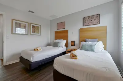 two beds in a room with white walls at Encantada Resort Vacation Townhomes by IDILIQ in Kissimmee