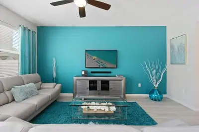 a living room with a couch and a tv at Four Bedroom with GameRoom 5150A in Kissimmee
