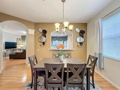 a dining room with a table and chairs at Disney World Vacation.. Luxury 6 BR/4 BA 5 Star Villa in Orlando