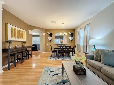 a living room with a couch and a table at Disney World Vacation.. Luxury 6 BR/4 BA 5 Star Villa in Orlando
