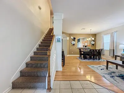 a staircase leading to a living room and dining room at Disney World Vacation.. Luxury 6 BR/4 BA 5 Star Villa in Orlando