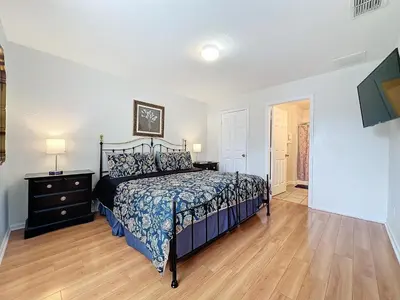 a bedroom with a bed and a dresser and a lamp at Disney World Vacation.. Luxury 6 BR/4 BA 5 Star Villa in Orlando