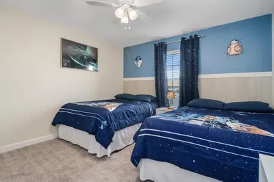 a bedroom with two beds and a ceiling fan at Four Bedrooms with Screen PoolStoreyLake 4910 in Kissimmee