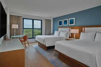 a hotel room with two beds and a desk at Walt Disney World Swan in Orlando