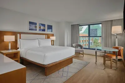 a hotel room with a bed and a desk and a window at Walt Disney World Swan in Orlando