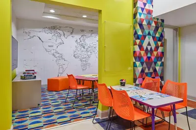 a classroom with tables and chairs and a map of the world at Walt Disney World Dolphin in Orlando