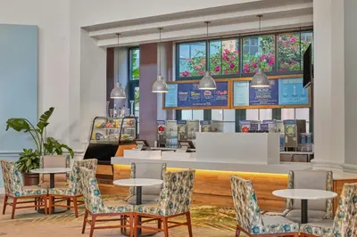 a restaurant with tables and chairs and a counter at Walt Disney World Dolphin in Orlando