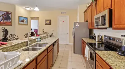 a kitchen with a sink and a refrigerator at Executive 3 Bedroom Villa at Universal,Convention Center, Vista Cay in Orlando