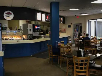 a restaurant with a counter and tables and chairs at Enclave Apartments at International Drive in Orlando
