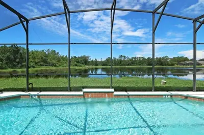 a swimming pool with a view of a lake at Aquamarine Hideaway in Kissimmee