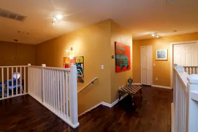 a living room with a staircase and a white door at Aquamarine Hideaway in Kissimmee