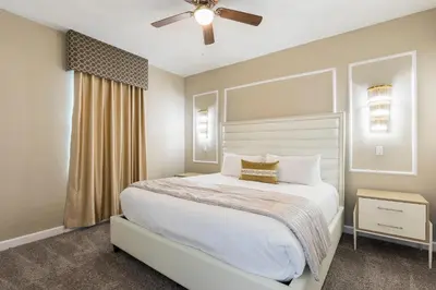a bedroom with a bed and a ceiling fan at Modern Luxury Villa with Everything in Kissimmee