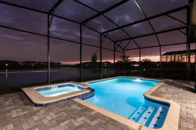 a large swimming pool with a roof at Modern Luxury Villa with Everything in Kissimmee