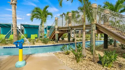 a resort with a slide and a pool at Modern Luxury Villa with Everything in Kissimmee