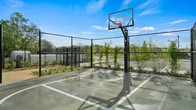 an empty basketball court with a basketball hoop at Modern Luxury Villa with Everything in Kissimmee