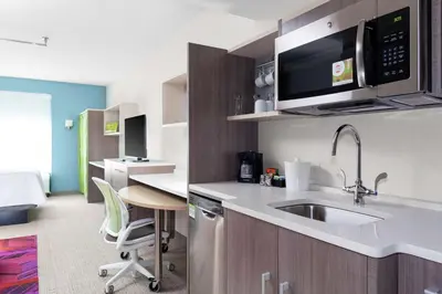 a kitchen with a sink and a microwave at Home2 Suites By Hilton Orlando South Park - Near Epic Universe in Orlando