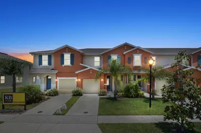 a house in a subdivision with a driveway at 4Bd Sleeps 9 w Jacuzzi Close to Disney @ Compass Bay 5113C in Kissimmee