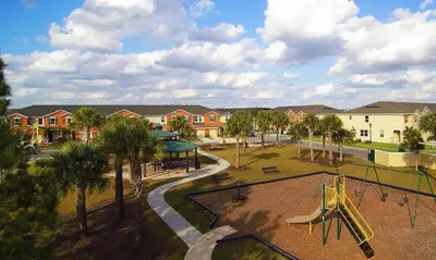 a playground with a slide in a park at 4Bd Sleeps 9 w Jacuzzi Close to Disney @ Compass Bay 5113C in Kissimmee