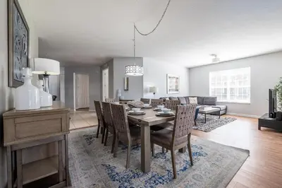 a dining room and living room with a table and chairs at Casa Lucia Lakeview Condo in Orlando