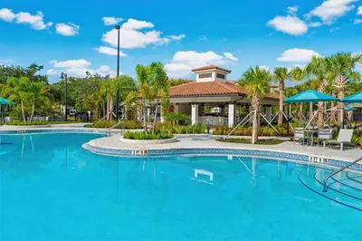 a pool at a resort with blue water at Casa Lucia Lakeview Condo in Orlando