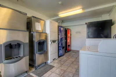 a kitchen with stainless steel refrigerators and a counter at Motel 6-Orlando, FL - Winter Park in Orlando