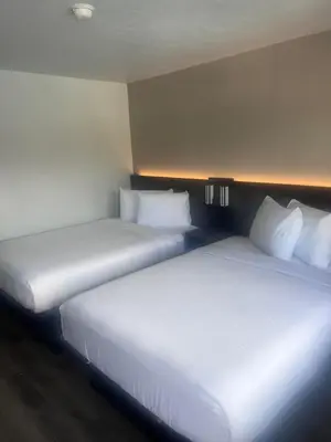 two beds sitting next to each other in a room at Motel 6-Orlando, FL - Winter Park in Orlando