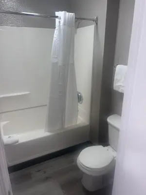 a bathroom with a white toilet and a shower at Motel 6-Orlando, FL - Winter Park in Orlando
