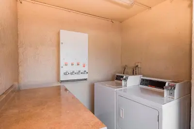 a laundry room with a washer and dryer at Red Roof Inn Orlando South - Florida Mall in Orlando