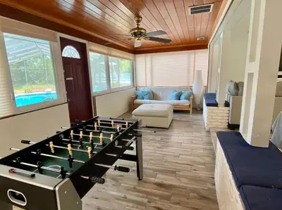 a living room with a large foos ball at Lakefront 7 Bedroom Duplex, Pool, Boat, and Hottub in Orlando