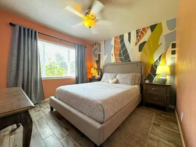 a bedroom with a bed and a ceiling fan at Lakefront 7 Bedroom Duplex, Pool, Boat, and Hottub in Orlando