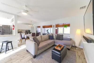 a living room with a couch and a table at Lakefront 7 Bedroom Duplex, Pool, Boat, and Hottub in Orlando
