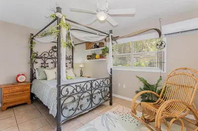 a bedroom with a bed and a ceiling fan at Spacious Lakefront House with Pool, Hottub, & Boating in Orlando