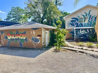 a house with a mural on the side of it at Spacious Lakefront House with Pool, Hottub, & Boating in Orlando