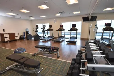 a gym with several rows of exercise equipment in a room at Holiday Inn Express & Suites - Orlando - Southeast by IHG in Orlando