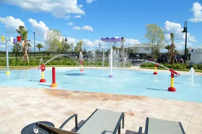 a pool with a water fountain in a park at Four Bedrooms at StoreyLakeResort 3063 in Kissimmee
