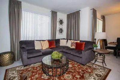 a living room with a couch and a table at Four Bedrooms at StoreyLakeResort 3063 in Kissimmee