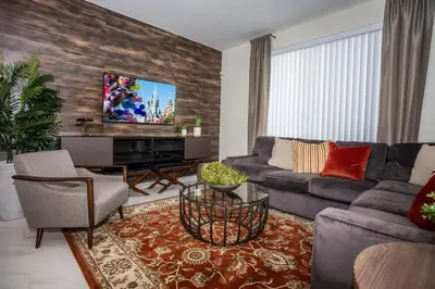 a living room with a couch and a tv at Four Bedrooms at StoreyLakeResort 3063 in Kissimmee