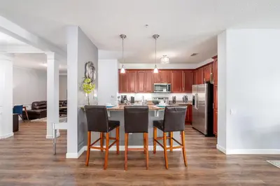 a kitchen with a table and chairs in a room at Cayview Avenue Unit 103 Condo in Orlando