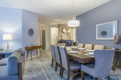 a dining room and living room with a table and chairs at Shoreway Loop Unit 108 Condo in Orlando