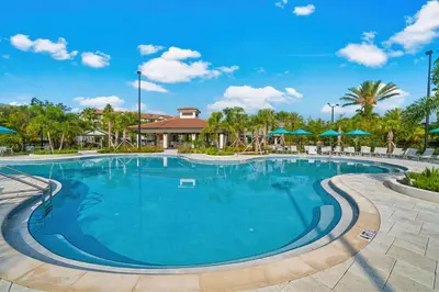a large swimming pool at a resort with umbrellas at Cayview Avenue Unit 404 Condo in Orlando