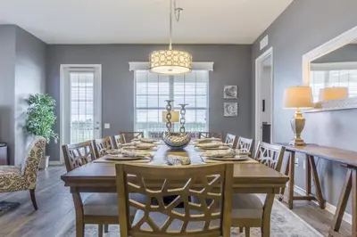 a dining room with a wooden table and chairs at Cayview Avenue Unit 404 Condo in Orlando
