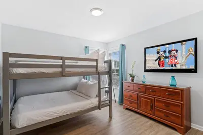 a bedroom with a bunk bed and a tv at Sun Palm 8119 in Kissimmee