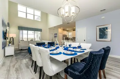 a dining room and living room with a white table and chairs at Beautiful Home wPrivate Pool & Spa, near WDW in Kissimmee